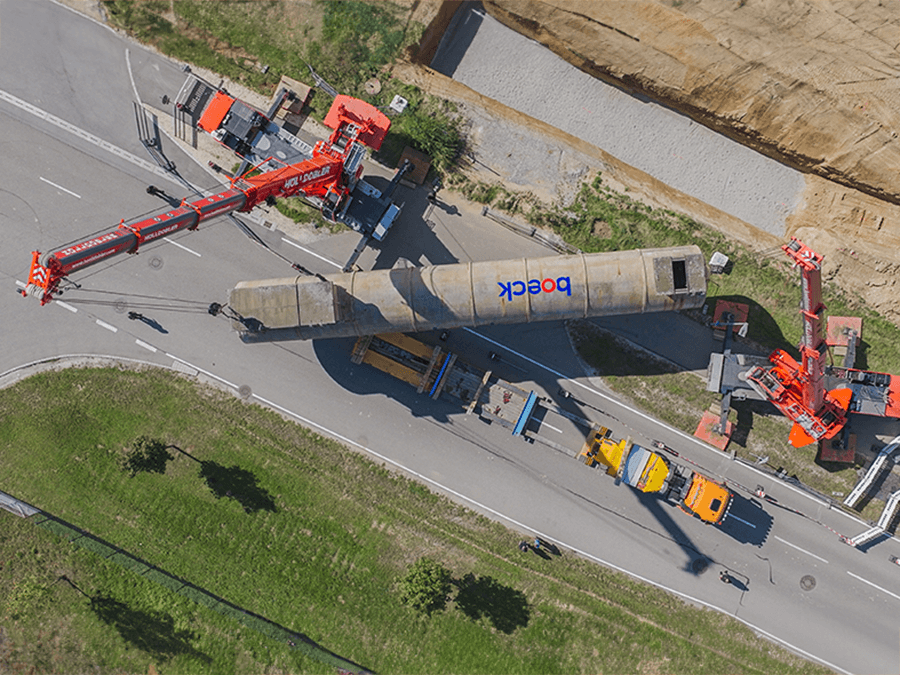 An extinguishing water tank is deployed by two heavy mobile cranes